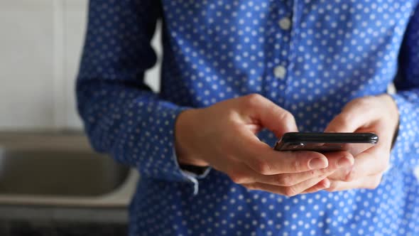 Caucasian woman using her phone at home