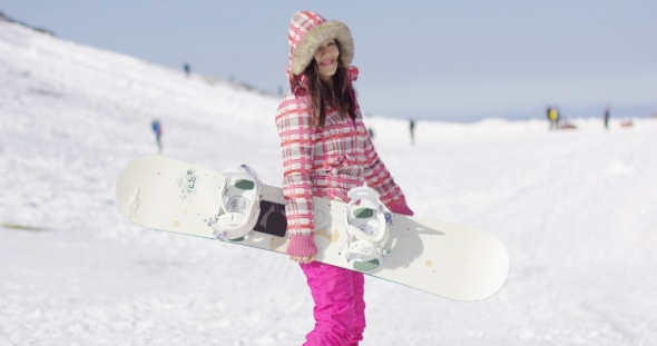 Happy Cute Female Snowboarder on Ski Slope.