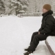 A Young Man Sits on a Bench in Winter Park and Admiring the Snow - VideoHive Item for Sale