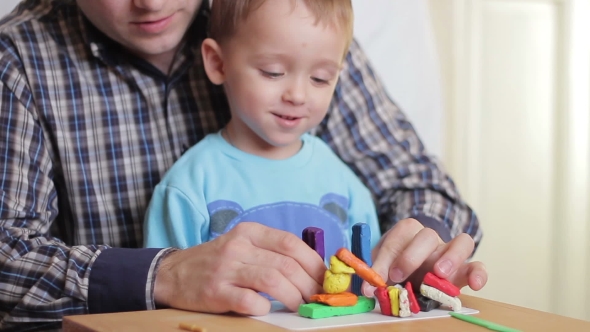 Happy Dad and Child Together Playing with Plasticine