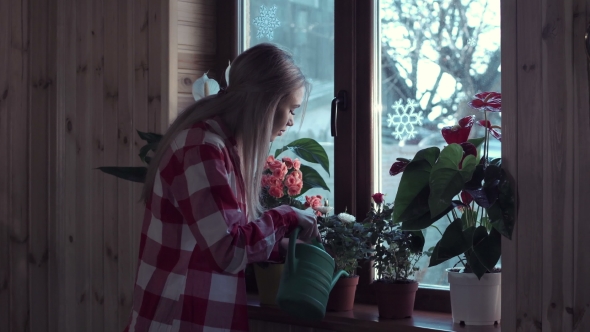 Young Woman Watering Flowers with Pot