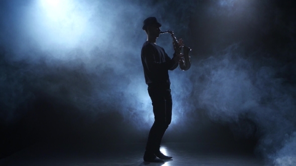 Slow Motive on the Saxophone. Musician in a Smoky Studio