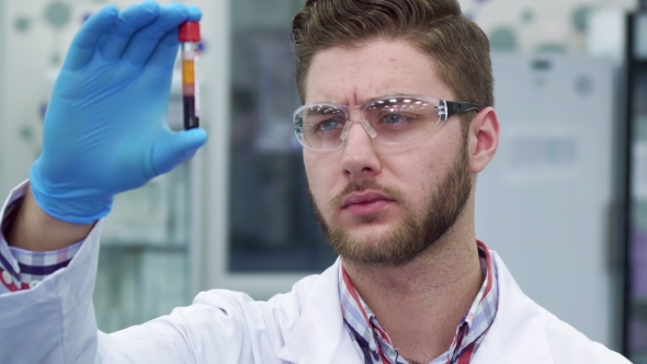 Man Holds Test-tube in His Hand at the Laboratory