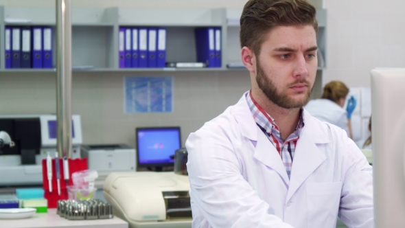 Man Looks at the Monitor at the Laboratory