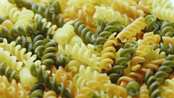 Uncooked Pasta in the Form of Spiral of Different Colors