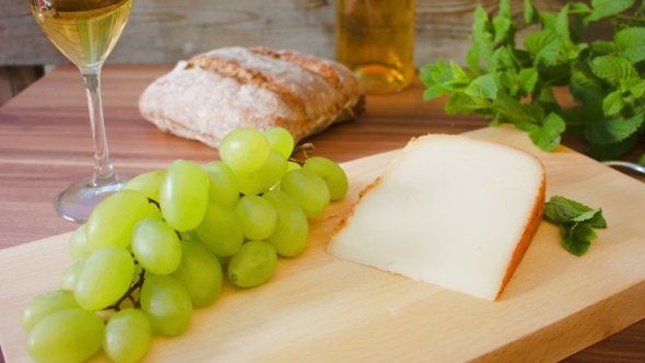 Hard Cheese with White Wine. Grapes and Bread