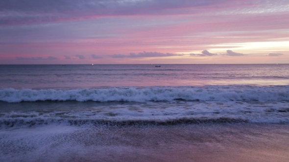 Waves in Magically Pink Sunset Over the Sea.