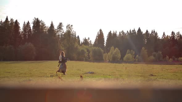 Carefree Female Dancing in Field