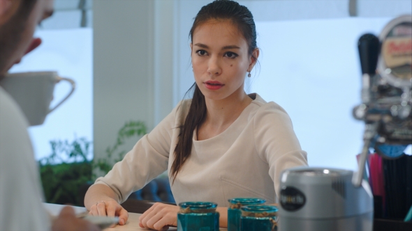 Pretty Brunette Not Happy with Her Coffee and Giving It Back To the Waiter