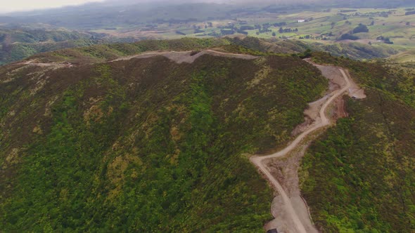 Rugged hill top road construction with vehicles moving. Manawatu New Zealand.