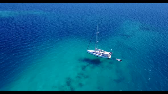 Aerial flying over tourism of relaxing coastline beach trip by blue green water with white sandy bac