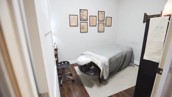 Chiropractor's adjustment room with a massage table and desk.