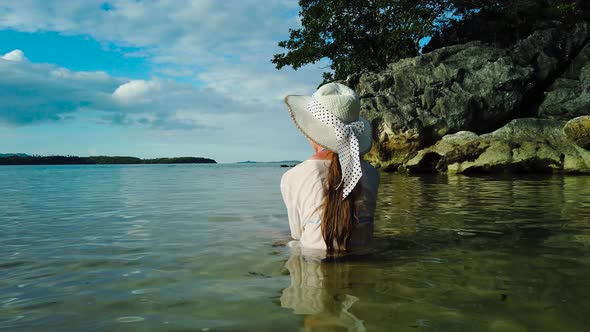 Girl in a Hat on the Beach