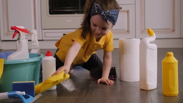 A Daughter Helps Her Mother Clean the House She Cleans the Floor with a Rag