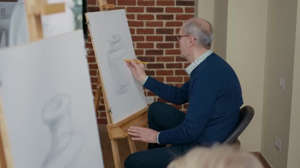 Elder Person Attending Art Class Lesson with Young Teacher