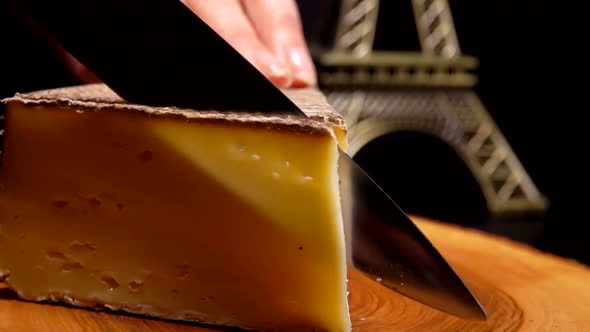 Knife Cuts a Thin Slice of Hard Cheese