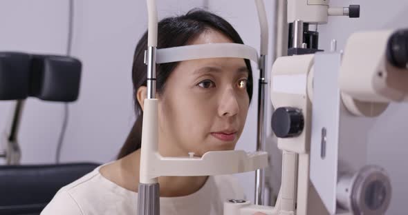 Woman do eye test at clinic