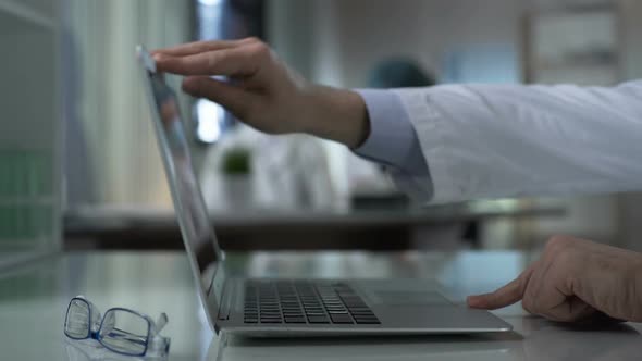 Scientist Opening Laptop to Start Work on Research Project in Lab, Medicine