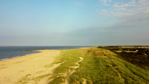 Eccles sandy sea beach with scenic grassland at Norfolk, England - dolly shot