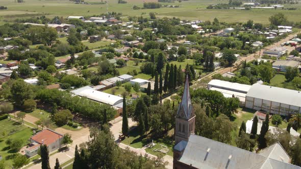 Track left of a romantic style church with Santa Anita town in background, Entre Rios, Argentina