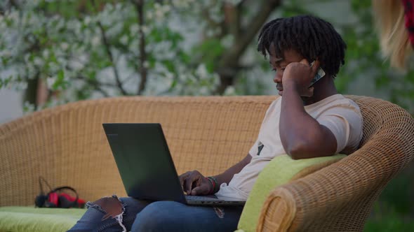 Young Busy Handsome African American Man Discussing Project Strategy Talking on Smartphone From