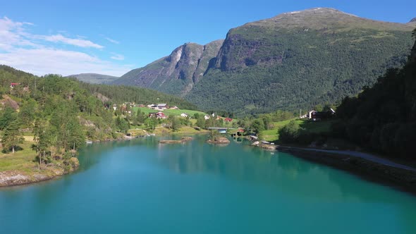 Lake bottom Lovatnet in beautiful summer sunshine with mountain Hoven and Loen Skylift far in the ba