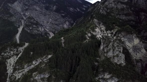 Aerial view of the mountains and forest in Borgo Valsugana in Trentino Italy with drone flying down