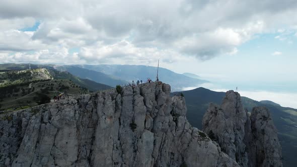 Tourists on a High Cliff Near a Cliff