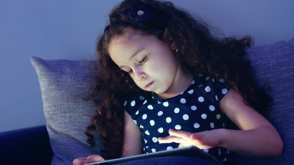 Cute Child Entertaining With Tablet. Little Girl Spending Leisure Time Playing Mobile Game