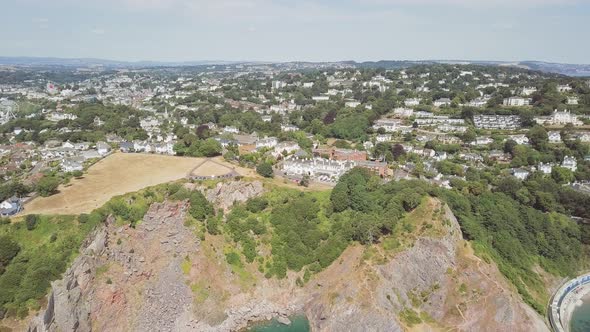 Aerial view of the town of Torquay in southwest England. Coastal town in Devon. Cliffs and agricultu