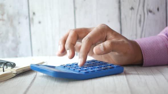 Close Up of Accountant Using Calculator on Office Desk