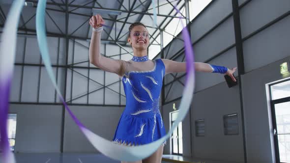 Female gymnast performing at sports hall