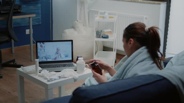 Woman with Cold and Flu Using Video Call for Telemedicine