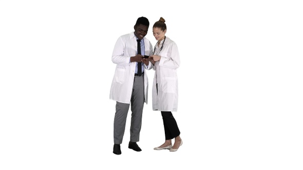 Medical team looking at phone together on white background
