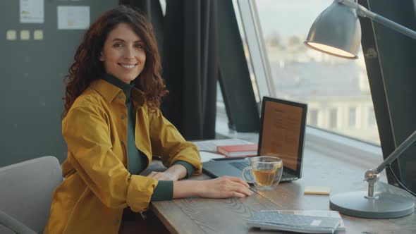 Portrait of Beautiful Businesswoman at Workplace in Modern Office