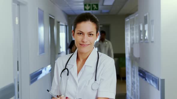 Female doctor standing in the corridor at hospital 4k