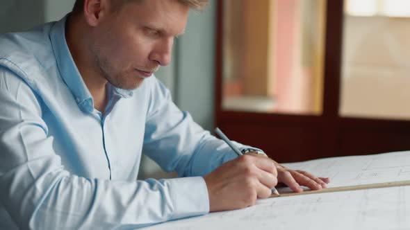 Smiling young architect at work in office