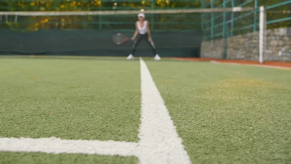 Young Woman Playing Tennis on Court