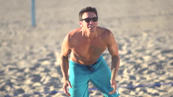 Man playing beach volleyball.