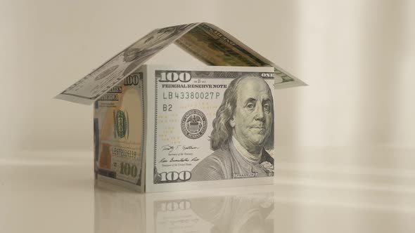 Home built with USD paper currency 4K 2160p 30fps UltraHD tilting footage - Real estate metaphor mad