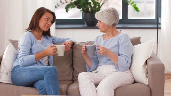 Senior Mother and Daughter with Coffee Talking 