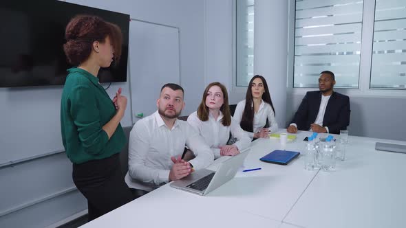 Project Managers Discussing Workflow at Meeting