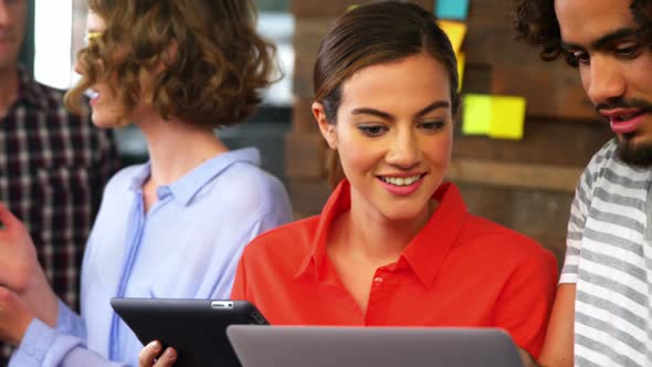 Business executives discussing over digital tablet in meeting