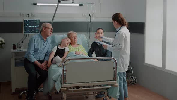 Sick Grandma and Family Talking to Physician About Healthcare