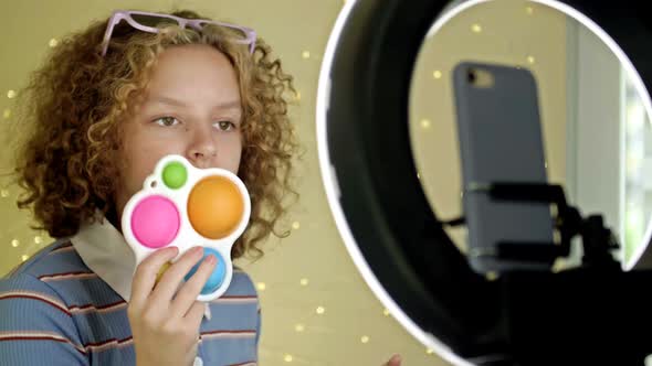 Blogger Girl Makes a Video Review of Antistress Toys at Home