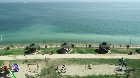 People Walking By the Sea