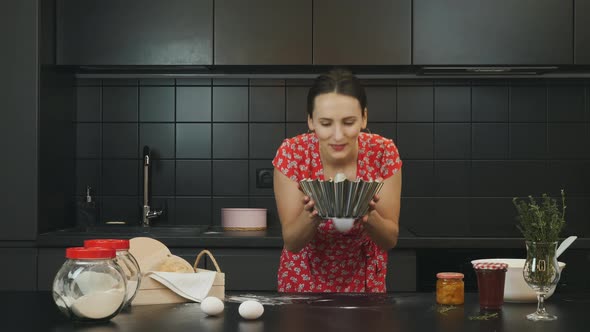 Woman puts pie in oven in modern home professional kitchen. Food and healthy lifestyle concept