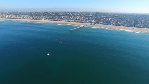 Aerial shot of surfers paddling out on the ocean.