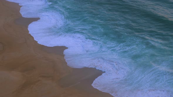 Aerial Ocean Waves on the Shore of a Ginger Beach in Cloudy Weather Slow Motion