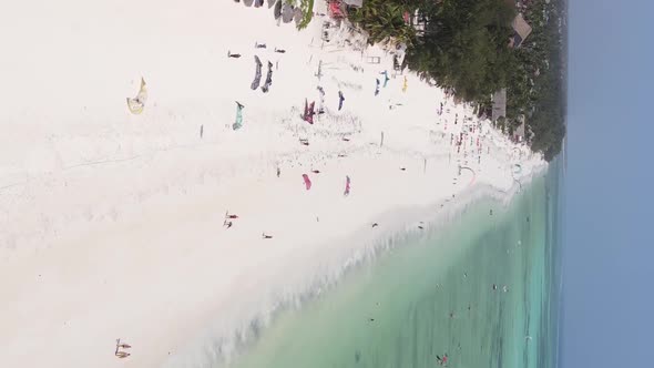 Vertical Video Kitesurfing Near the Shore of Zanzibar Tanzania Aerial View